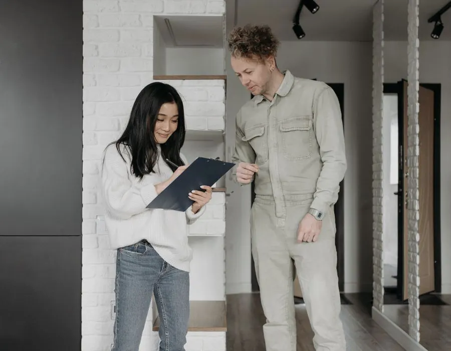 Homeowner reviewing a job quote with a contractor inside a home