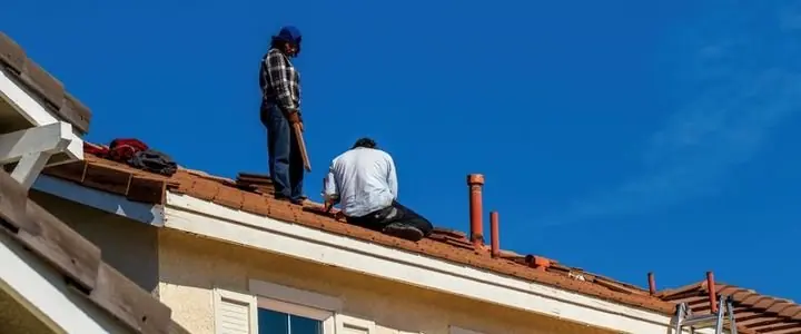 Roofing crew replacing a residential roof