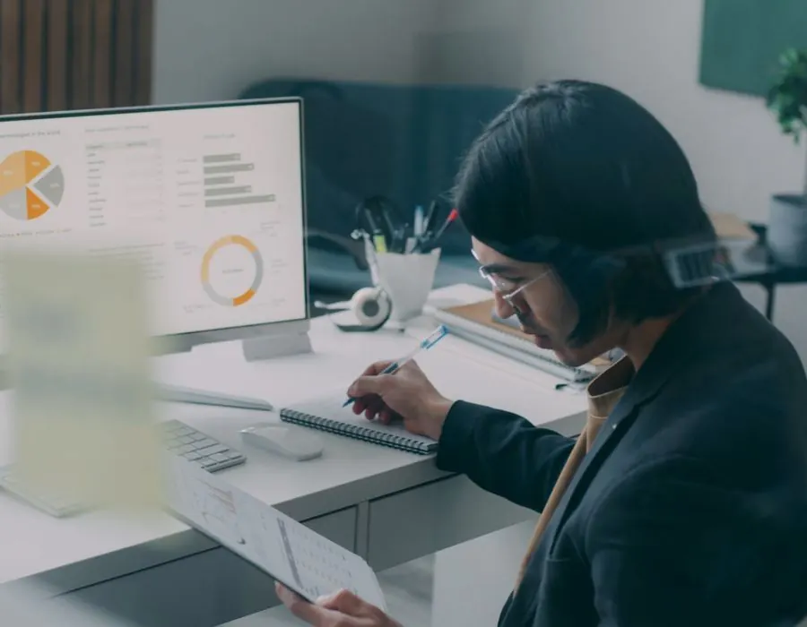 Analyst comparing a reporting dashboard against a printed order report